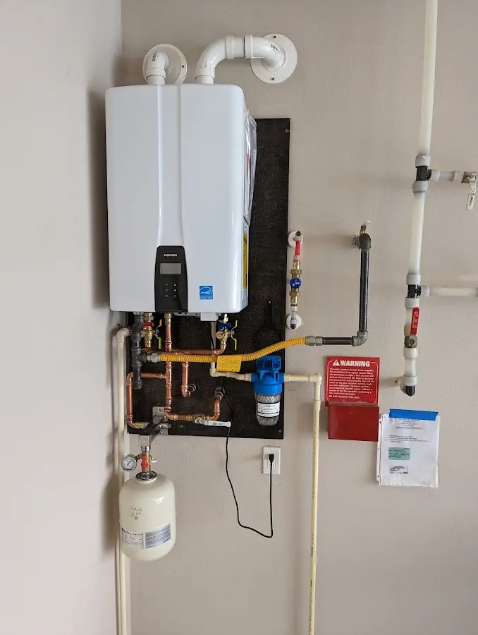 Professional plumber installing copper piping in a Norwood home